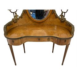 Late 19th century amboyna and ormolu mounted dressing table, the raised oval mirror with bevelled plate supported by sweeping raised back mounted with cast merfigures holding two branch sconces, decorated with scrolled leaf and floral festoons, kidney shaped form with satinwood band, fitted with three drawers, on turned tapering supports with gilt metal caps