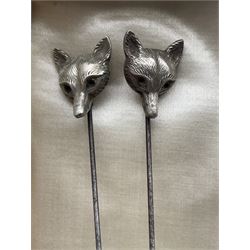 Three silver stick pins, two formed as foxes' heads and the other as a teddy bear, hallmarked Birmingham 1909, together with a cased set of six Imperial Plate brandy pans by Furber & Sons Cheltenham 