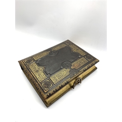 Victorian tooled leather photograph album 'The Seaside Album' with lithographed pages and six air musical movement with key 