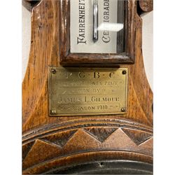 An Edwardian English solid oak carved hall barometer in a scroll shaped carved case with applied leaf carving, compensated Aneroid movement, seven-inch register measuring barometric air pressure from twenty-six to thirty-one inches, weather predictions written in Roman capitals with a blue steel indicating hand and recording hand, brass bezel with flat bevelled glass, mercury thermometer enclosed in a glazed rectangular box recording temperature in degrees Fahrenheit and Celsius, brass presentation plaque dated 1910.

With a 20th century wall clock with a Smiths going barrel “Empire” movement and platform escapement, 11” metal dial with roman numerals and minute track, steel spade hands, fast slow regulation, with a spun bezel mounted on an oak effect dial bezel and wooden movement case.
