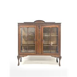 Early 20th century walnut display cabinet, raised back over gadroon moulded top, two glazed doors enclosing two shelves, raised on acanthus leaf carved cabriole supports W124cm, H141cm, D32cm