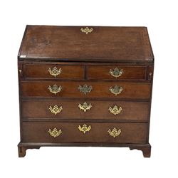 George III oak bureau, the fall front enclosing a fitted interior over two short and three long graduated drawers, raised on bracket supports 
