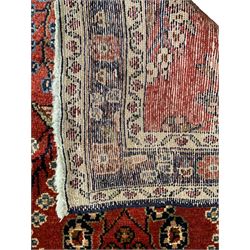 Persian Hamadan red ground runner, overall floral design, the field decorated with clusters of trailing flowerhead motifs, the border decorated with repeating pattern within guard bands