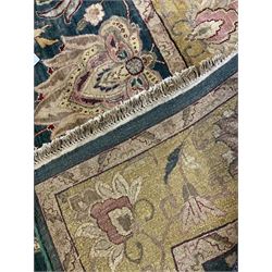 Indo-Persian emerald ground thick pile carpet, the field decorated with large lotus and Boteh motifs connected by scrolling foliate tendrils, the guarded citrine border with stylised plant and lotus motifs