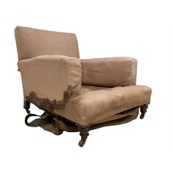 Late 19th century Howard design walnut framed armchair, sprung back and seat upholstered in neutral zigzag patterned fabric, raised on turned supports terminating in brass and ceramic castors