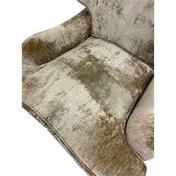 Laura Ashley - wide seat armchair, upholstered in champagne coloured crushed velvet fabric, raised on turned feet with brass castors