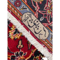 Small Persian Kashan red ground rug, the field decorated with interlacing foliage and stylised plant motifs, central indigo ground medallion, the guarded border decorated with scrolling branch and flower heads, signature to each end