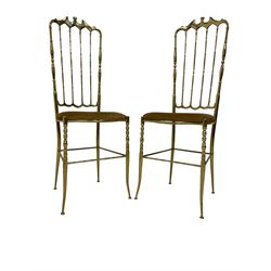 Pair gilt metal chiavari style chairs, after a design by Giuseppe Gaetano Descalzi, high back with shaped cresting rail over turned spindles, upholstered seat with turned front supports joined by stretchers 