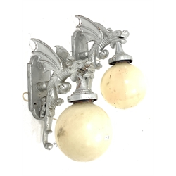Pair of modern cast metal wall lights, each modelled as a winged dragon with globular shades, H68cm approx