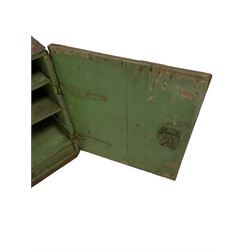 Early to mid-19th century painted pine campaign cupboard, the ebonised exterior with iron fittings and brass handle enclosing green painted interior, fitted with two pigeonholes and a single shelf over a narrow drawer