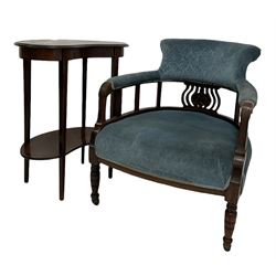 Victorian tub chair, the upholstered cresting rail over galleried back, raised on turned supports and ceramic castors, together with an Edwardian rosewood two tier table