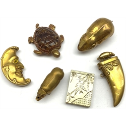 Six novelty vesta cases comprising  embossed brass man in the moon, another in the form of a tigers claw, mouse, pig, turtle and a plated vesta inscribed '1884'