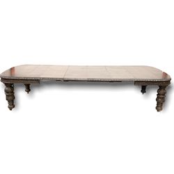 Large Victorian oak wind out extending dinging table, the top with four additional leaves, raised on baluster turned supports terminating in castors, profusely carved all over with oak leaves and foliate 352cm x 136cm, H77cm