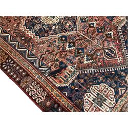 Persian Qashqai indigo ground rug, the central Gul medallion replicated in the spandrels, within a busy field decorated with stylised geometric plant and animal motifs, the maroon field with repeating tree of life motifs and flower heads