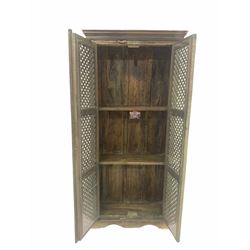 Indian painted hardwood cupboard, the lattice panelled doors enclosing two shelves, raised on shaped plinth base W86cm, H185cm, D37cm