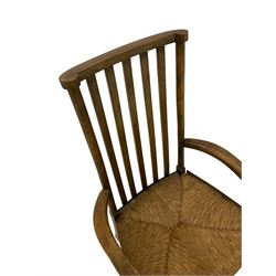 Early 20th century beech armchair, high slatted back with shaped arms and rush seat