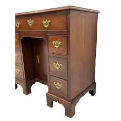 George III mahogany kneehole desk, the moulded rectangular top over one long frieze and six smaller cockbeaded drawers, with a recessed cupboard enclosing a single shelf, fitted with shaped and pierced handle plates and drop handles, lower moulding over bracket feet