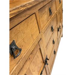 Alan 'Acornman' Granger - Yorkshire oak dresser, with two height plate rack over five drawers and two panelled cupboards, each enclosing a shelf, raised on octagonal supports, carved with acorn signature, W137cm, H167cm, D49cm