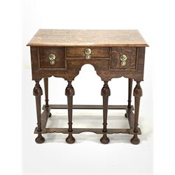 17th century style oak lowboy, rectangular top with moulded edge over three drawers and shaped apron, raised on turned supports united by shaped stretcher 73cm x 48cm, H68cm