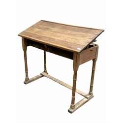 19th century limed oak clerks desk, the hinged angle adjustable top raised on four ring turned supports with sledge feet united by stretcher W102cm