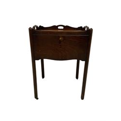 George III mahogany bedside cabinet, rectangular tray top with shaped raised sides and pierced handles, single sliding cupboard door with shaped apron, raised on quarter curved chamfered supports terminating in small brass castors, 