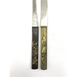 Two Japanese Meiji Kozuka, the first decorated in high relief with Samurai figures in mixed metals with gilt highlights, the steel blade signed, the second having a brass handle relief decorated with fish with two steel blades, unsigned  L21cm , both in display cases (2)