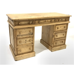 Early 20th century pine twin pedestal desk, the top section fitted with three drawers, over two banks of three drawers, raised on a skirted base