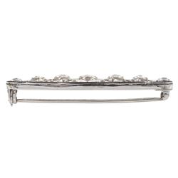 14ct white gold graduating seven stone diamond openwork brooch,with black enamel border, total diamond weight approx 0.80 carat  