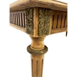 Regency style mahogany table, the moulded rectangular top with quarter veneers and boxwood stringing, fluted frieze with cast gilt metal leaf mounts, turned and fluted tapering supports