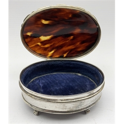Silver oval dressing table box with hinged tortoiseshell cover on shaped supports W10cm Birmingham 1920 Maker Mappin and Webb, pair of silver menu holders inset with a portrait print Chester 1904, pair of silver and blue enamel decanter labels and two others