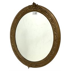 Gilt framed oval wall mirror with foliate design and beading 54cm x 46cm