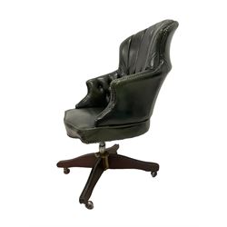 George III design swivel desk elbow chair, upholstered in dark olive green buttoned leather with studwork, raised on quadripod base with castors