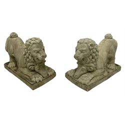 Pair of composite garden ornaments in the form of Dog of Foo, the lion in a crouched pose with a ram mask below
