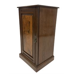 Early 20th century oak bedside cupboard, single fielded figured oak panelled door enclosing shelf, raised on plinth base 