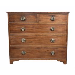 George III mahogany chest, the top with ebonised string inlay over two short and three long graduated cock beaded drawers with original plate brass pull handles, inlaid band to base, raised on bracket supports, retaining original blue paper lined drawers W110cm