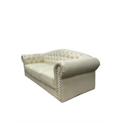 Chesterfield style three seat club sofa, upholstered and buttoned in cream fabric with stud work