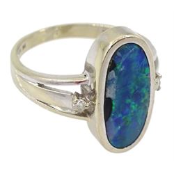 14ct white gold oval opal duplet ring, with a single diamond set either side, stamped 585