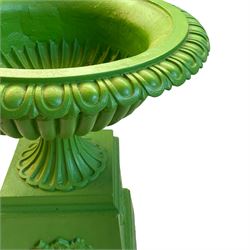20th century green painted cast iron urn on stand, egg and dart moulded rim over gadrooned underbelly and moulded footed base, on a tapered square base decorated with floral urns