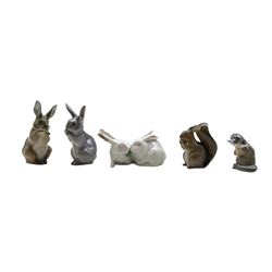 Five Royal Copenhagen porcelain figures comprising an Otter no. 2333 designed by Vilhelm Waldorff, Squirrel no. 982, two Rabbits no. 1019 and a pair of Rabbits no. 518 designed by Arnold Krog (5)