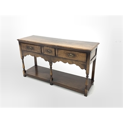 18th century style oak dresser, rectangular moulded top over three drawers, shaped apron, raised on turned and block supports united by pot board base