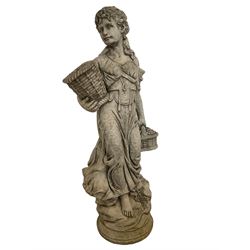 Composite stone garden figure modelled as an Italian maiden carrying baskets, on naturalist base with wild flowers