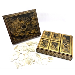 19th century Chinese black lacquer and gilt games box, of rectangular form, the body decorated with landscapes within stylised foliate borders, the cover opening to reveal an interior fitted with five lidded boxes containing mother of pearl counters, the majority engraved with the initials E.W. and the remaining engraved with Pagodas, together with stained ivory counters, L30cm, D26.5cm, H8cm 