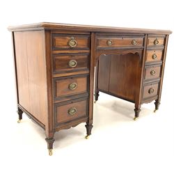 Edwardian mahogany twin pedestal desk, fitted with one long drawer and two banks of four graduating drawers, raised on square tapered supports with brass castors, W122cm, H76cm, D60cm