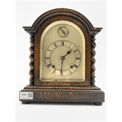 Early 20th century oak cased mantel cock, domed top over spiral turned pilasters and stepped base raised on compressed bun supports, Silvered dial with Roman numeral chapter ring, eight day movement with silent/ strike  function, W25cm