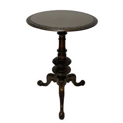 Victorian figured walnut tripod table, the circular top with quarter matched veneers and foliate carved edge, on turned and carved column, on three splayed and scrolled supports 