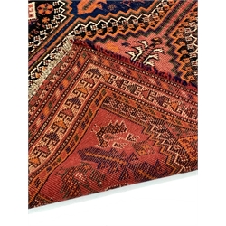  Oriental style red ground flat weave rug decorated with geometric designs and stylised chickens, 130cm x 272cm  
