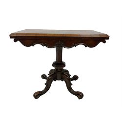 Victorian figured walnut fold over card table, the twist folding top opening to reveal baize playing surface, raised on a squared column leading into splayed and scrolled supports terminating in brass castors 
