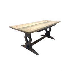 Rustic 20th century oak refectory style dining table, the two plank rectangular top raised on shaped and pierced panel end supports with sledge feet, united by stretcher 184cm x 80cm, H77cm
