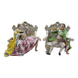 Pair of Hochst porcelain figures modelled as a male and female figure seated on an ornate sofa playing a flute and lute, H12cm (2)