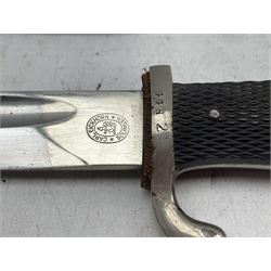 German Carl Eickhorn Solingen bayonet with two piece chequered grip and scabbard, squirrel mark, blade length 26cm